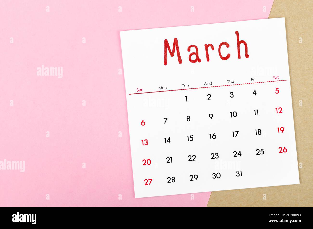 The March 2022 calendar on pink background with empty space. Stock Photo