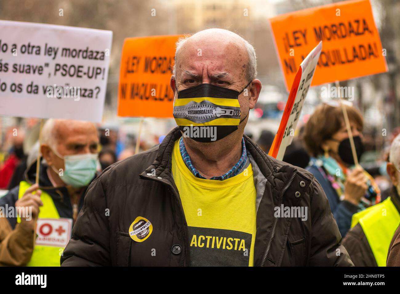 Madrid, Spain. 13th Feb, 2022. A man with the word 'ungag' on his face mask is seen during a demonstration against the Citizen Security Law known as Gag Law (Ley Mordaza). The citizen platform 'No Somos Delito', together with groups, organizations and social movements that work for the defense of Human Rights, have called for a demonstration to demand that the reform of the Gag Law proposed by Government respond to some minimums that guarantee the free exercise of fundamental rights. Credit: Marcos del Mazo/Alamy Live News Stock Photo