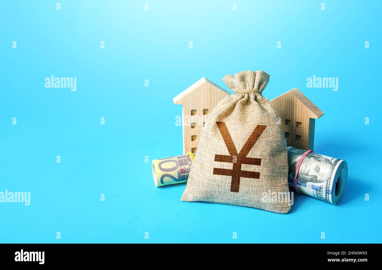 Houses and chinese yuan or japanese yen money bag. Asset, financial resource management. Building up capital, saving from inflation risks. Real estate Stock Photo