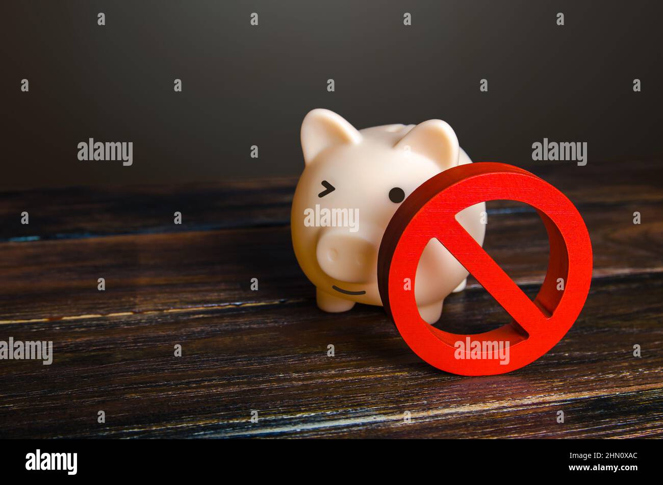 Piggy bank and prohibition sign NO. Bypass restrictions, loopholes in laws. Lifting of sanctions, unblocking and unfreezing of assets. Money launderin Stock Photo