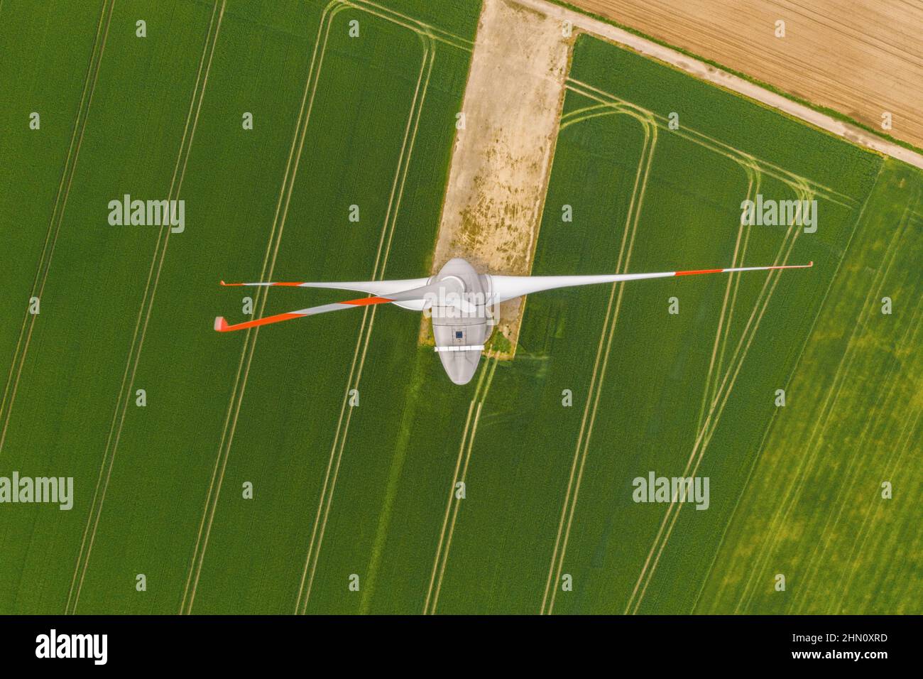 Aerial top down picture of wind turbine a device that converts the wind's kinetic energy into electrical energy providing renewable energy sustainable Stock Photo