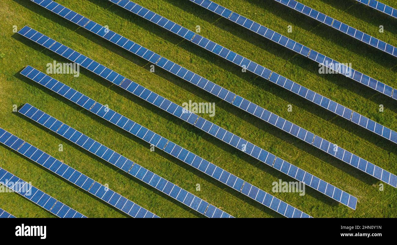 Aerial top down photo of solar panels PV modules mounted on ground photovoltaic solar panels absorb sunlight as a source of energy to generate electri Stock Photo