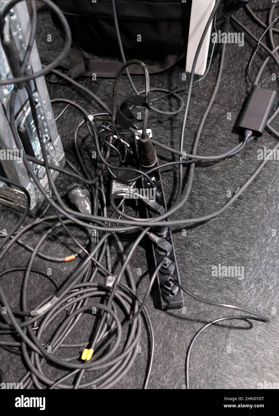 Chaotic electric cables on the ground Stock Photo