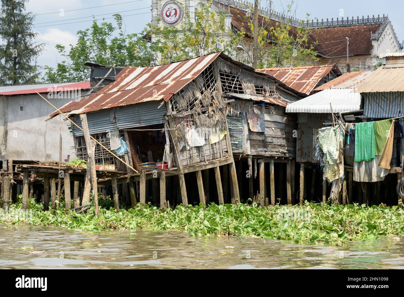 Traditional Vietnamese houses on stilts on the Mekong River, Cai Be