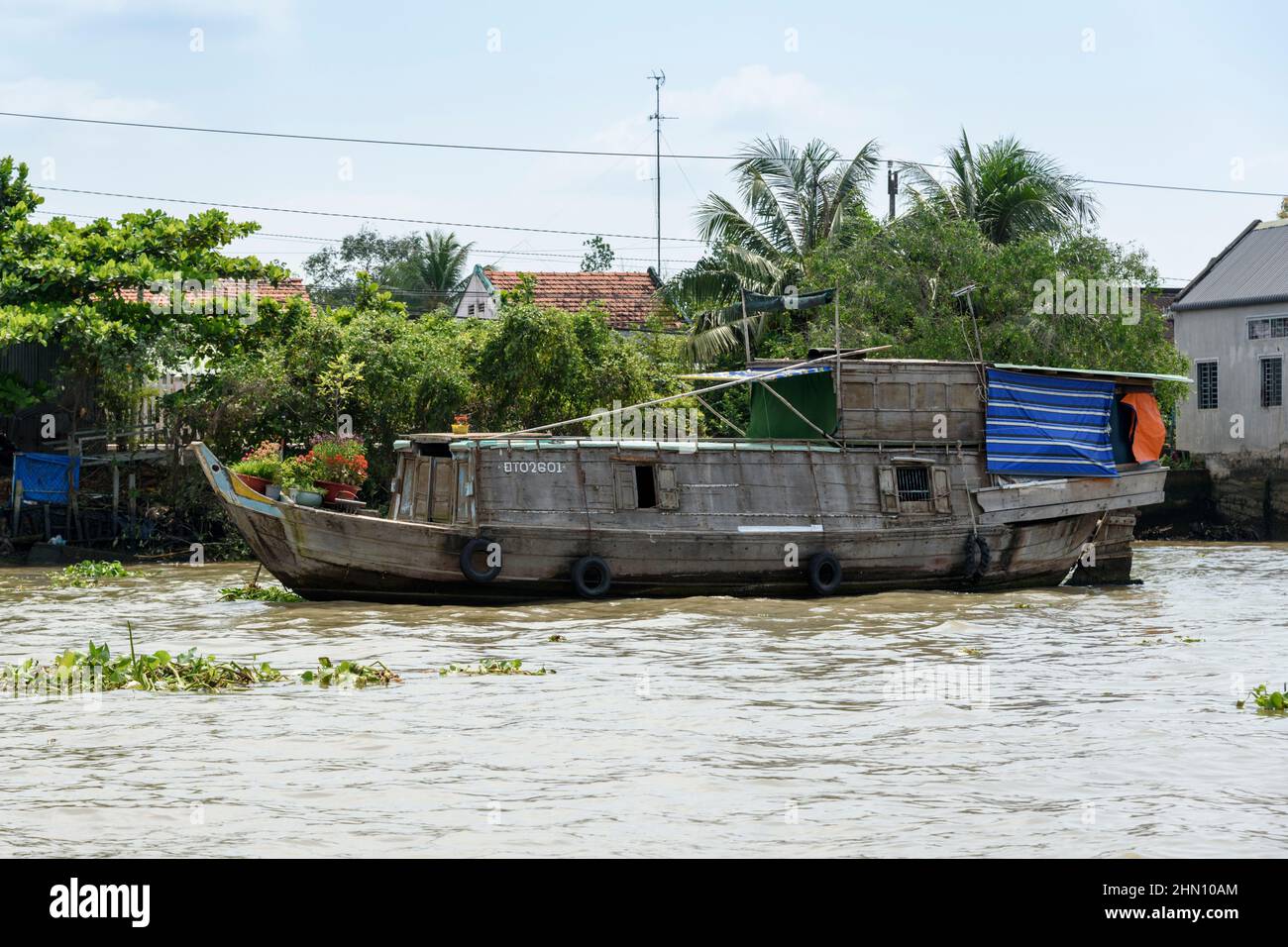 Traditional Vietnamese wooden houseboat on the Mekong River, Cai Be ...