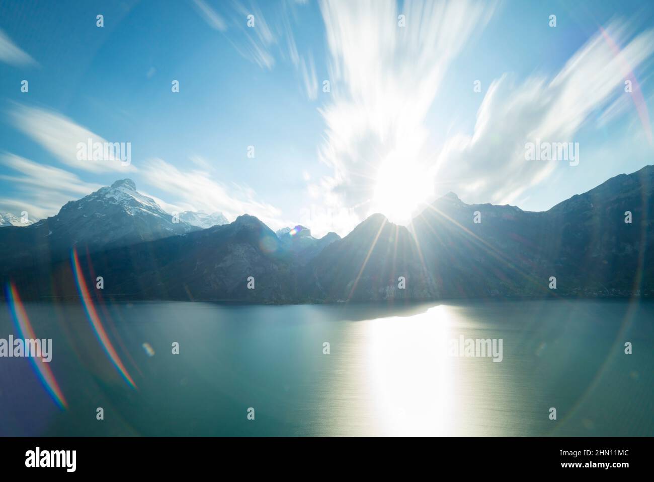 Strongly expressed strong lens flare of an extra wide lens. Long exposure. Mountainous landscape. Stock Photo