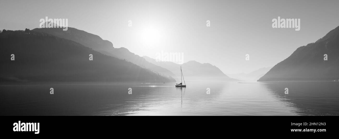 Panorama of the lake in the mountains. Sunlight rays. Stock Photo