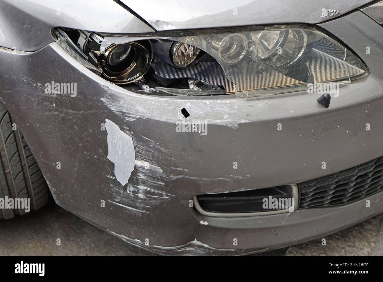 Damaged car broken headlights lens front bumper traffic accident Stock Photo