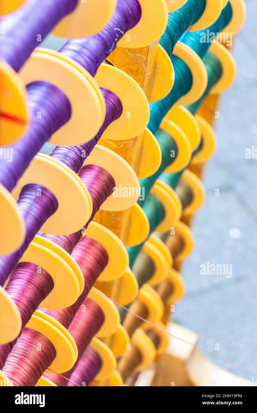 reels of coloured thread for weaving in the crafts area on Granville