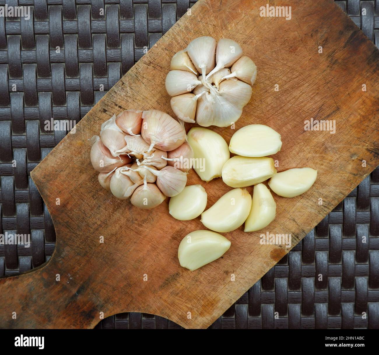 garlic. garlic cloves. peel the garlic clove. Garlic is one of the main spices in Indonesian cuisine Stock Photo