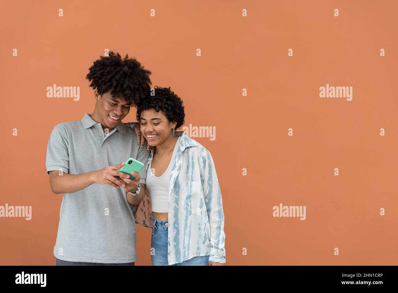 African American latin couple using smartphone, Panama, central America Stock Photo