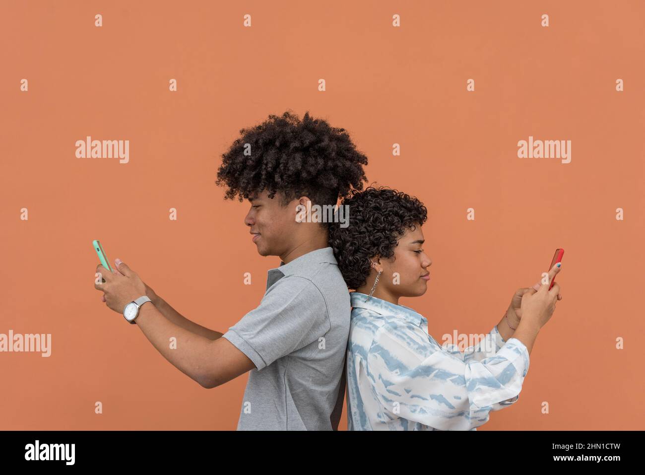 African American latin couple using smartphone,Panama, Central America Stock Photo