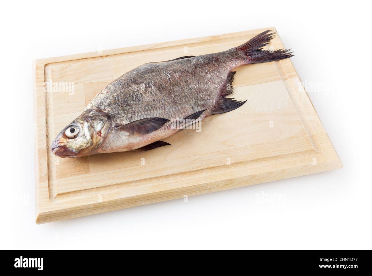 Common river bream on cutting board isolated on white background Stock Photo