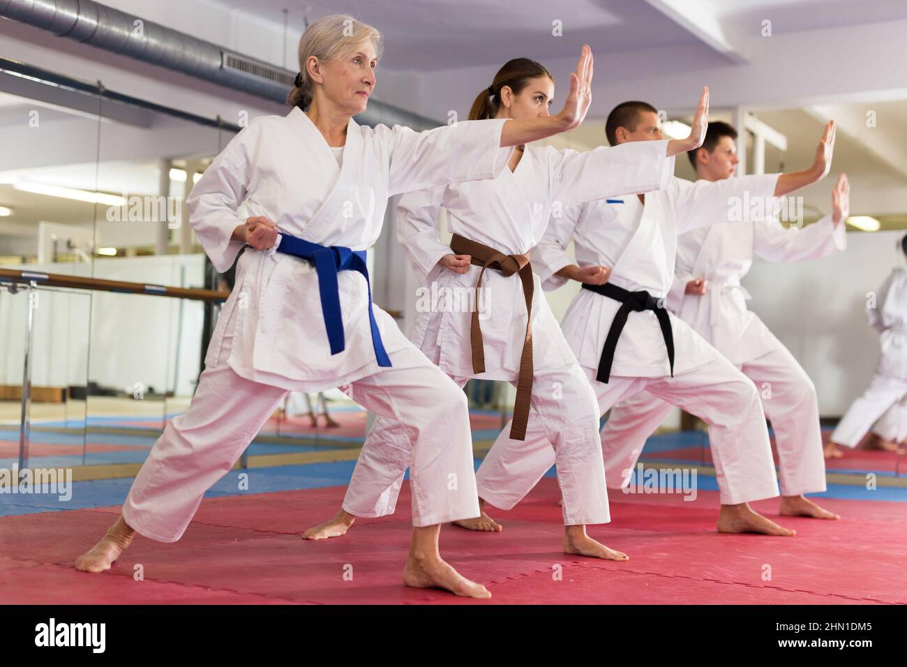 Karate or taekwondo training athletes in kimono stand in fighting
