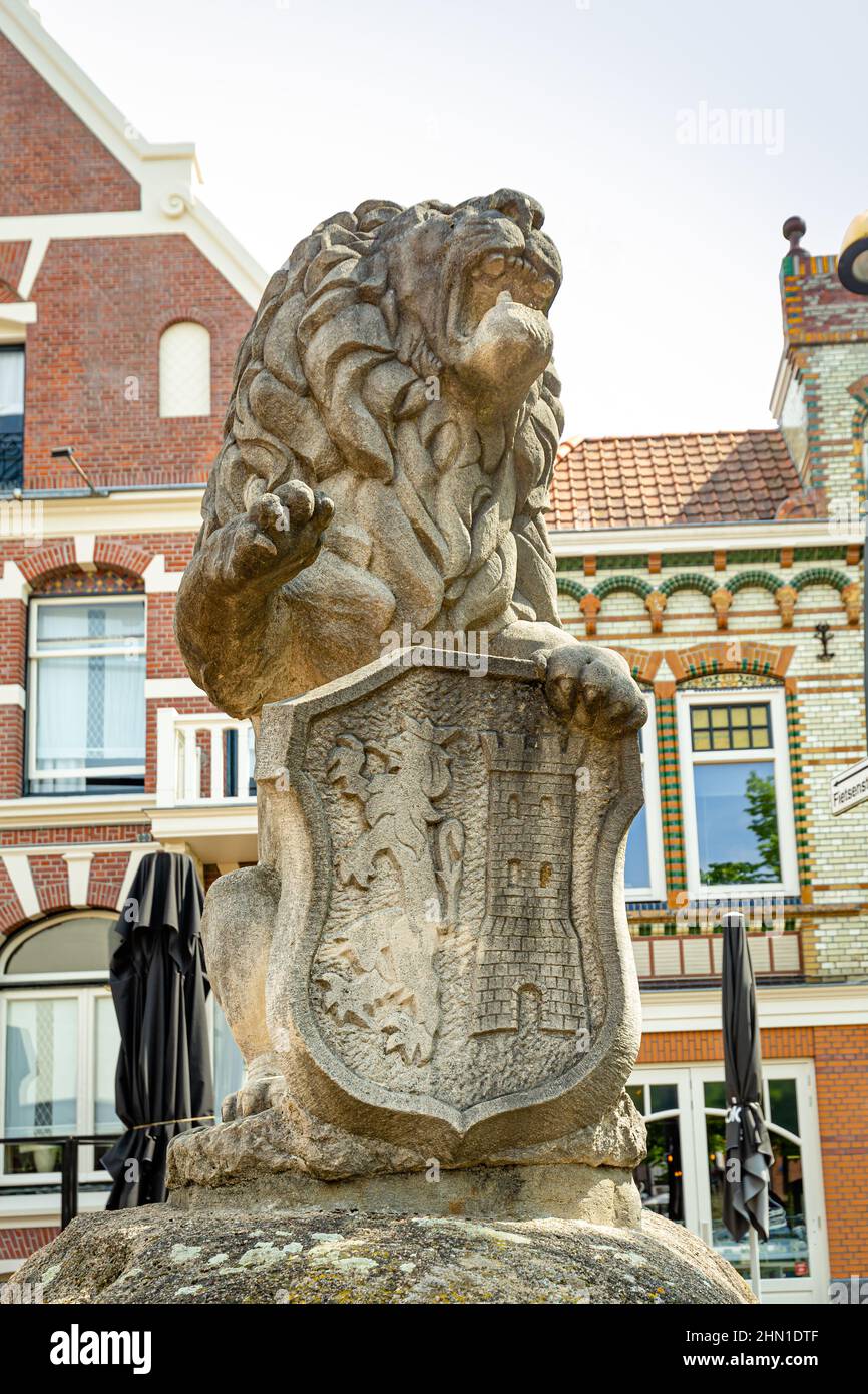 Lichtenvoorde, The Netherlands - May 14, 2021: Stone statue of lion with coat of arms at historic market square in th center of Lichtenvoorde Achterhoek in Gelderland The Netherlands Stock Photo