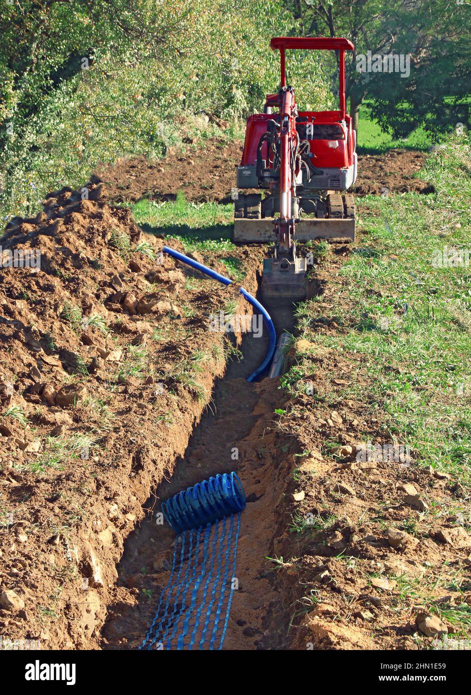 Laying pipes in the connecting trench of a house. Stock Photo