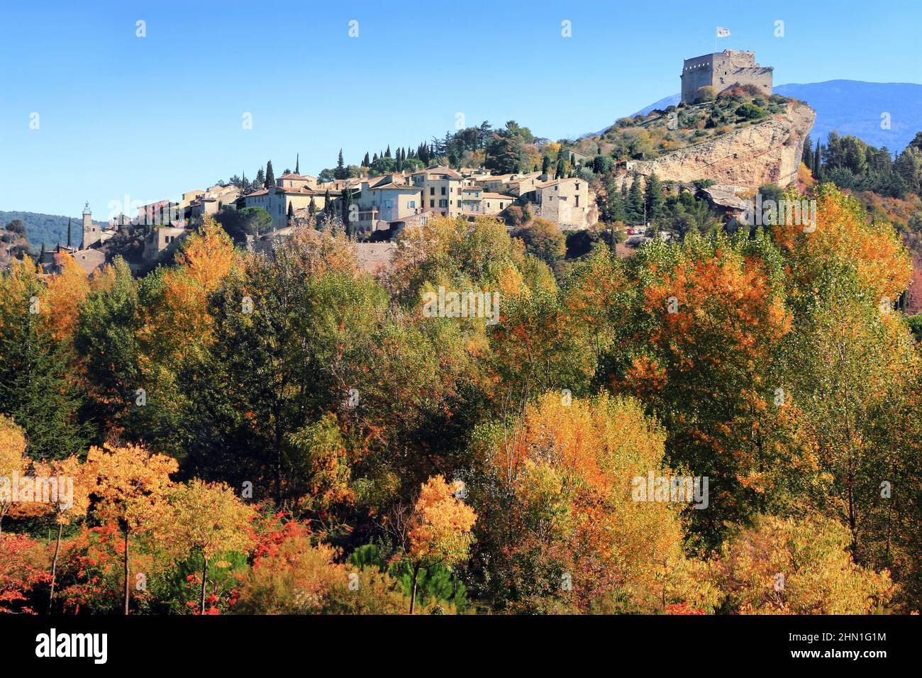 Autumn colors in front of the Provençal village of Vaison-la-Romaine. Stock Photo