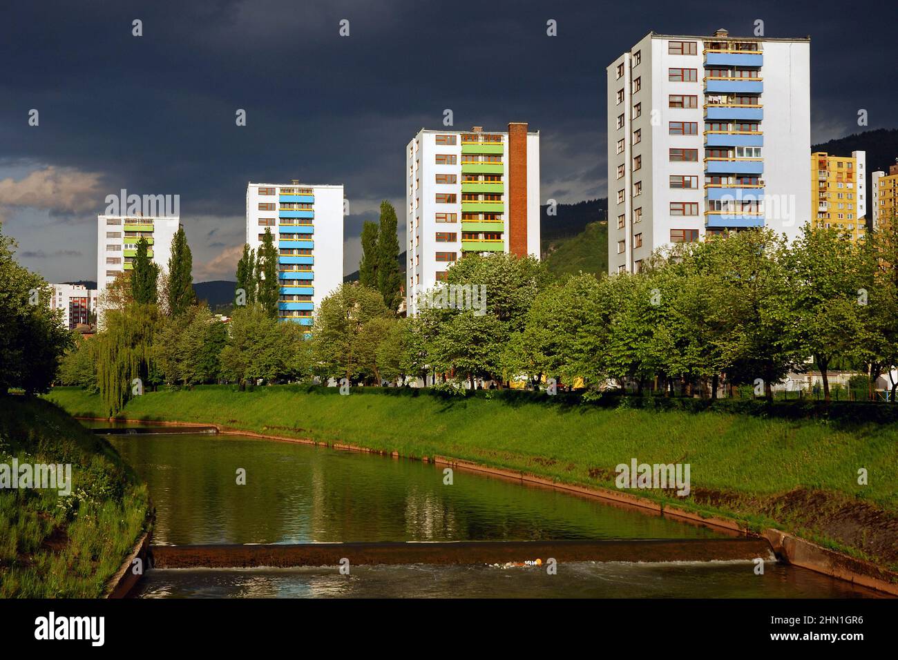 Buildings Near Miljacka River, Sarajevo, Vilsonovo setaliste, Dramatic Light, Architecture pattern and repetition. Yugoslav Cityscape Stock Photo