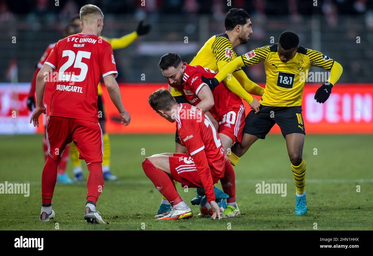 Berlin, Germany. 13th Feb, 2022. Soccer: Bundesliga, 1. FC Union Berlin - Borussia Dortmund, Matchday 22, An der Alten Försterei. Borussia Dortmund's Youssoufa Moukoko (r-l) and Mats Hummels fight for the ball against Berlin's Kevin Möhwald and Bastian Oczipka. Credit: Andreas Gora/dpa - IMPORTANT NOTE: In accordance with the requirements of the DFL Deutsche Fußball Liga and the DFB Deutscher Fußball-Bund, it is prohibited to use or have used photographs taken in the stadium and/or of the match in the form of sequence pictures and/or video-like photo series./dpa/Alamy Live News Stock Photo