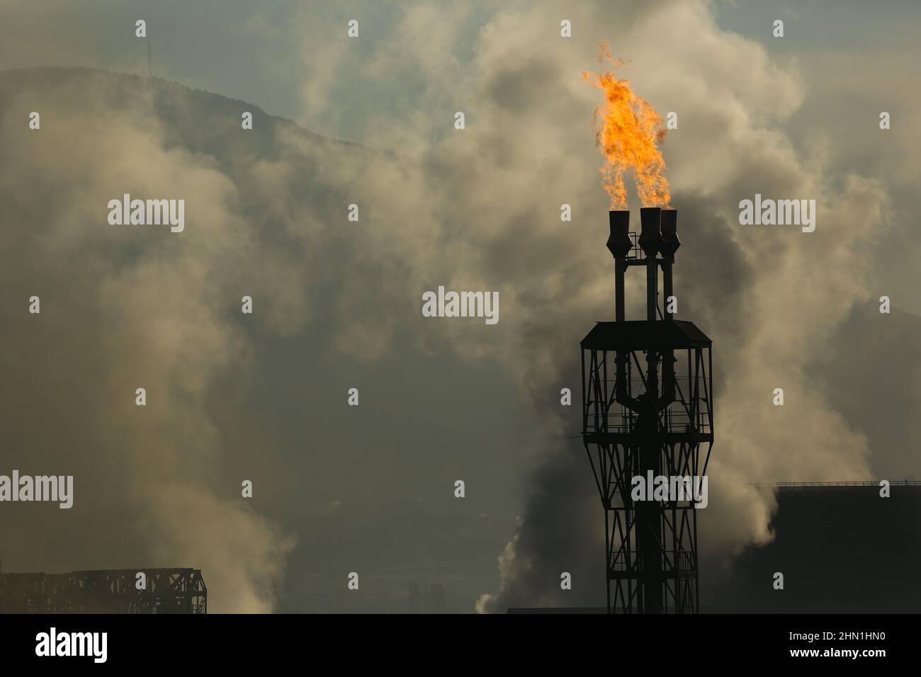 Heavy industry chimneys that produce smoke and fire. Air pollution illustration and damage to respiratory organs. Global warming and coal industry Stock Photo