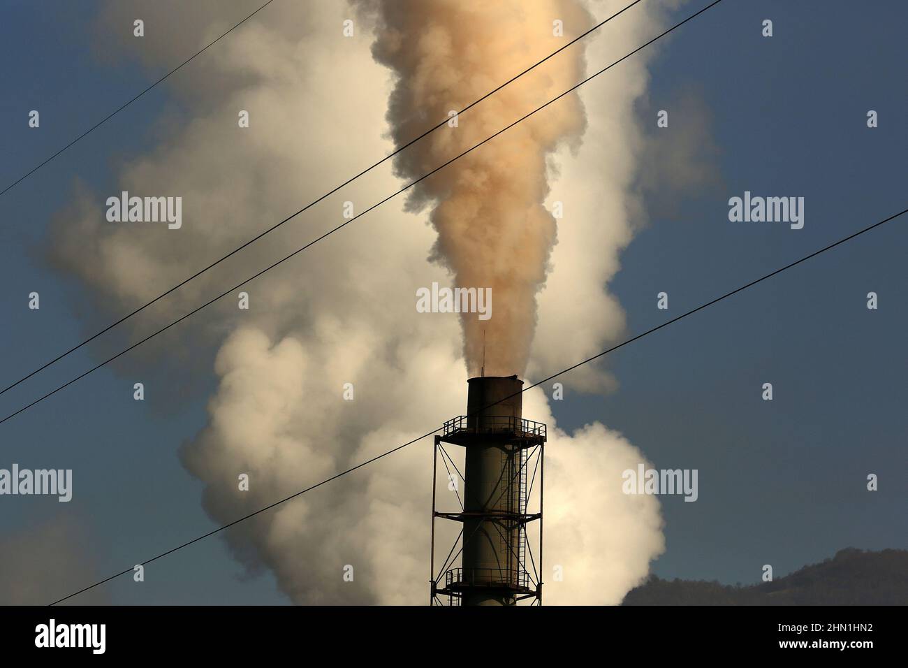 Heavy industry chimneys that produce smoke and fire. Air pollution illustration and damage to respiratory organs. Global warming and coal industry Stock Photo