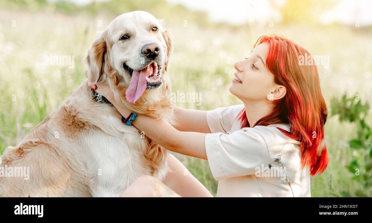 Teen girl with golden retriever dog Stock Photo - Alamy