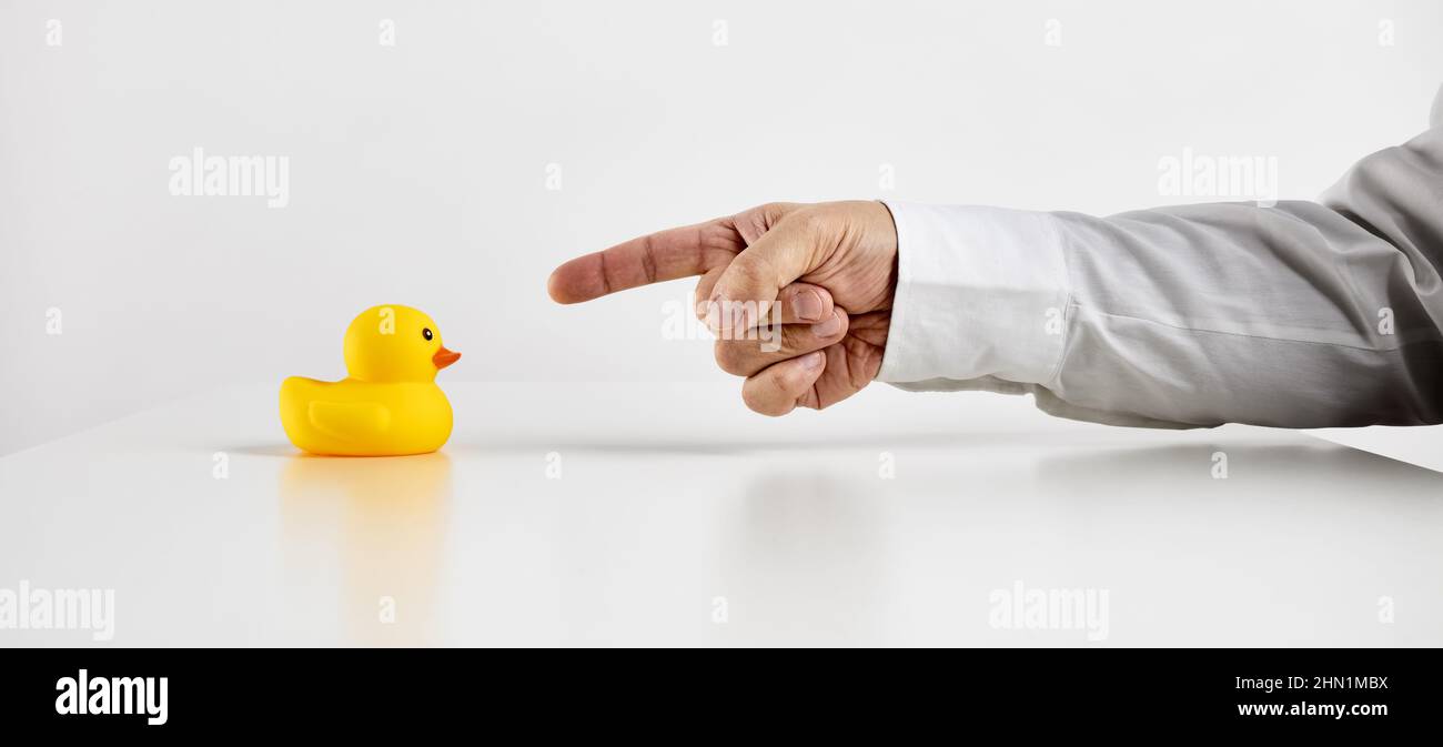 Scolding, anger, conflict, complaint, criticism, bullying or peer pressure in business concept. Business person points his finger towards the rubber d Stock Photo