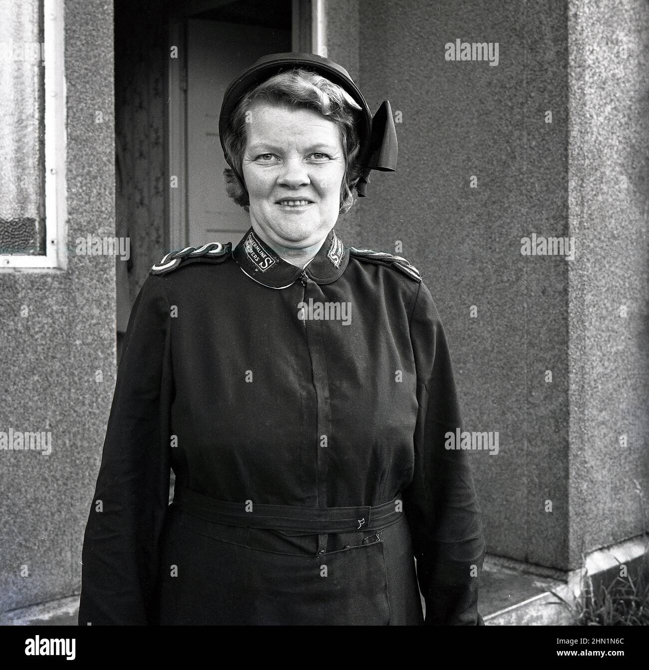 1960s, historical, standing for her picture outside a house, a lady in