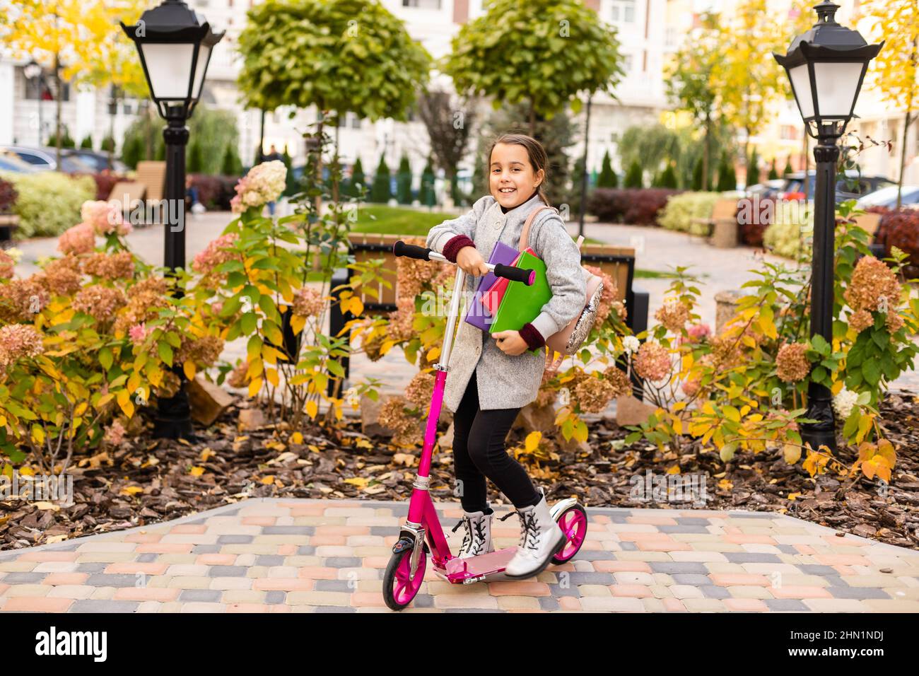 Beautiful little girl with backpack walking in the park ready back to ...