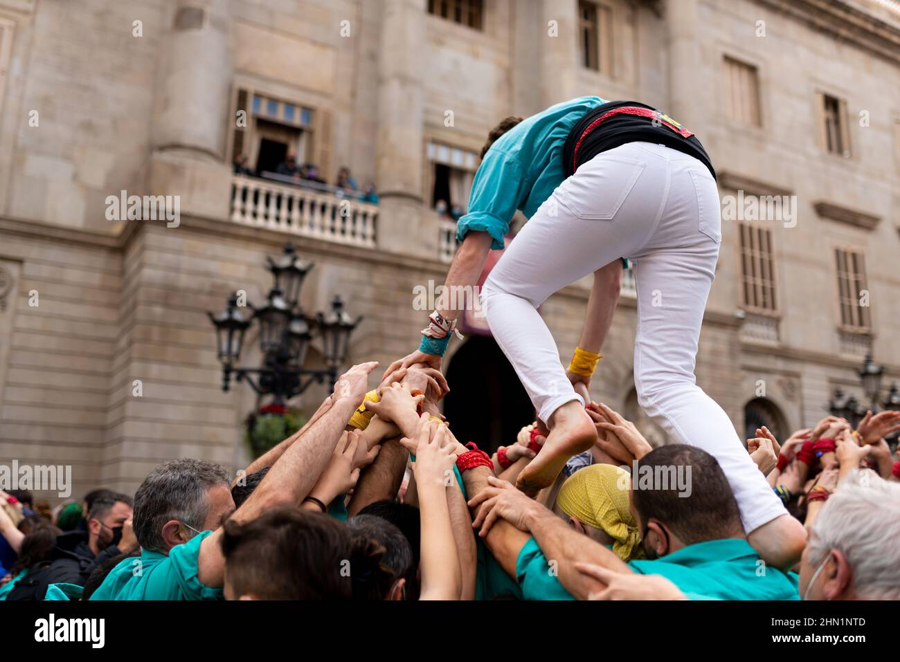 Spain. 13th Feb, 2022. People are seen holding the base of traditional Castellers with their hands as performances are held on occasion of the Saint Eulalia celebrations in Sant Jaume Square in Barcelona, Spain on February 13, 2022. The Castellers are traditional catalan human towers dating back to the 18th century, normally created during festivities and celebration in the spanish region of Catalonia. (Photo by Davide Bonaldo/Sipa USA) Credit: Sipa USA/Alamy Live News Stock Photo