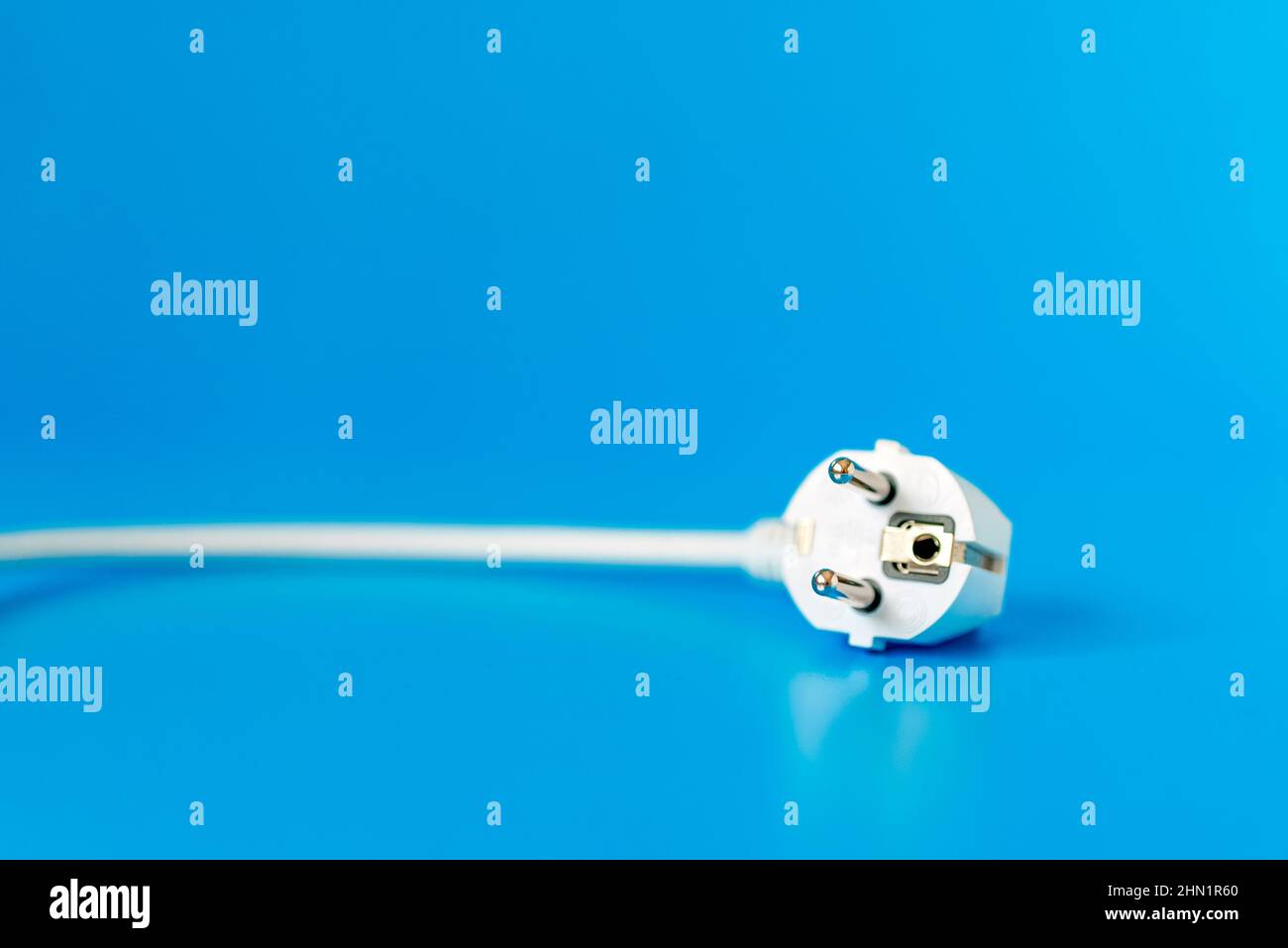 AC power plug on blue background Stock Photo - Alamy