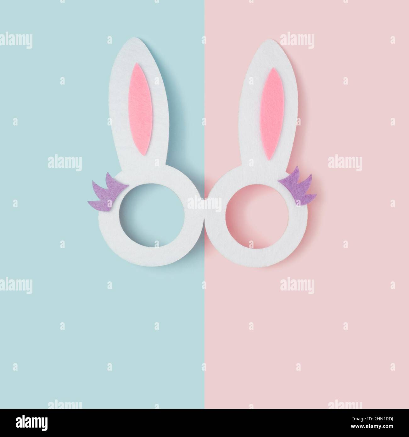 Bunny ears glasses on a two tone pastel background. Happy Easter