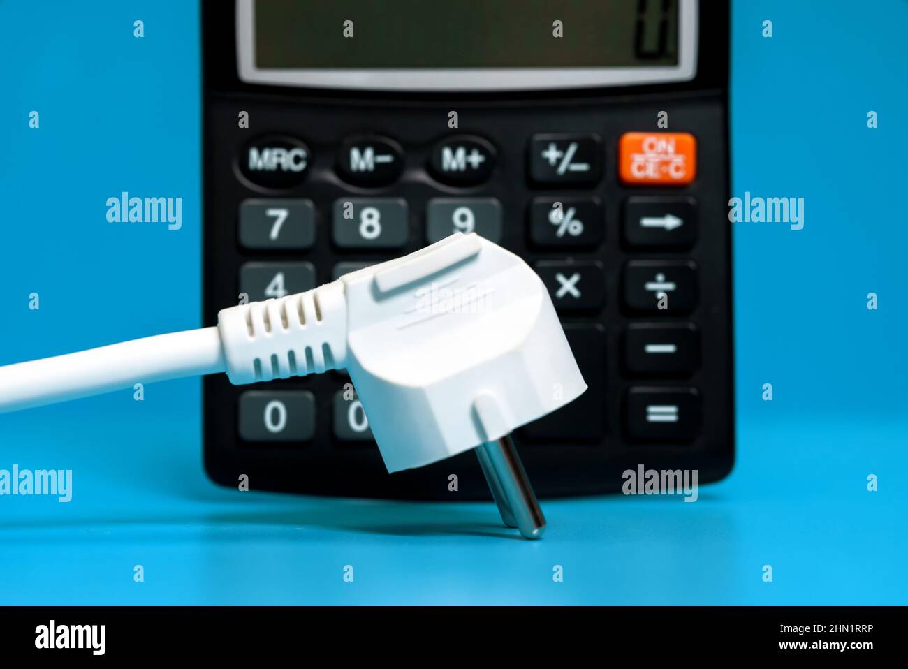Electricity growth concept. Calculator and AC power plug Stock Photo - Alamy