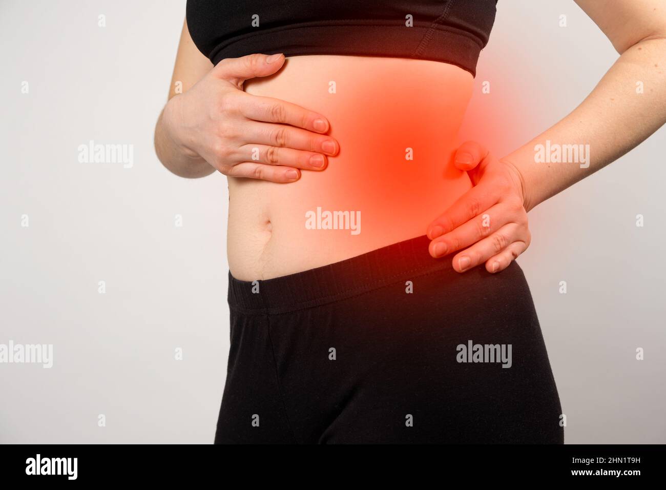 A woman shows the location of the pancreas and spleen, the large intestine. A close-up of the abdomen. Stock Photo