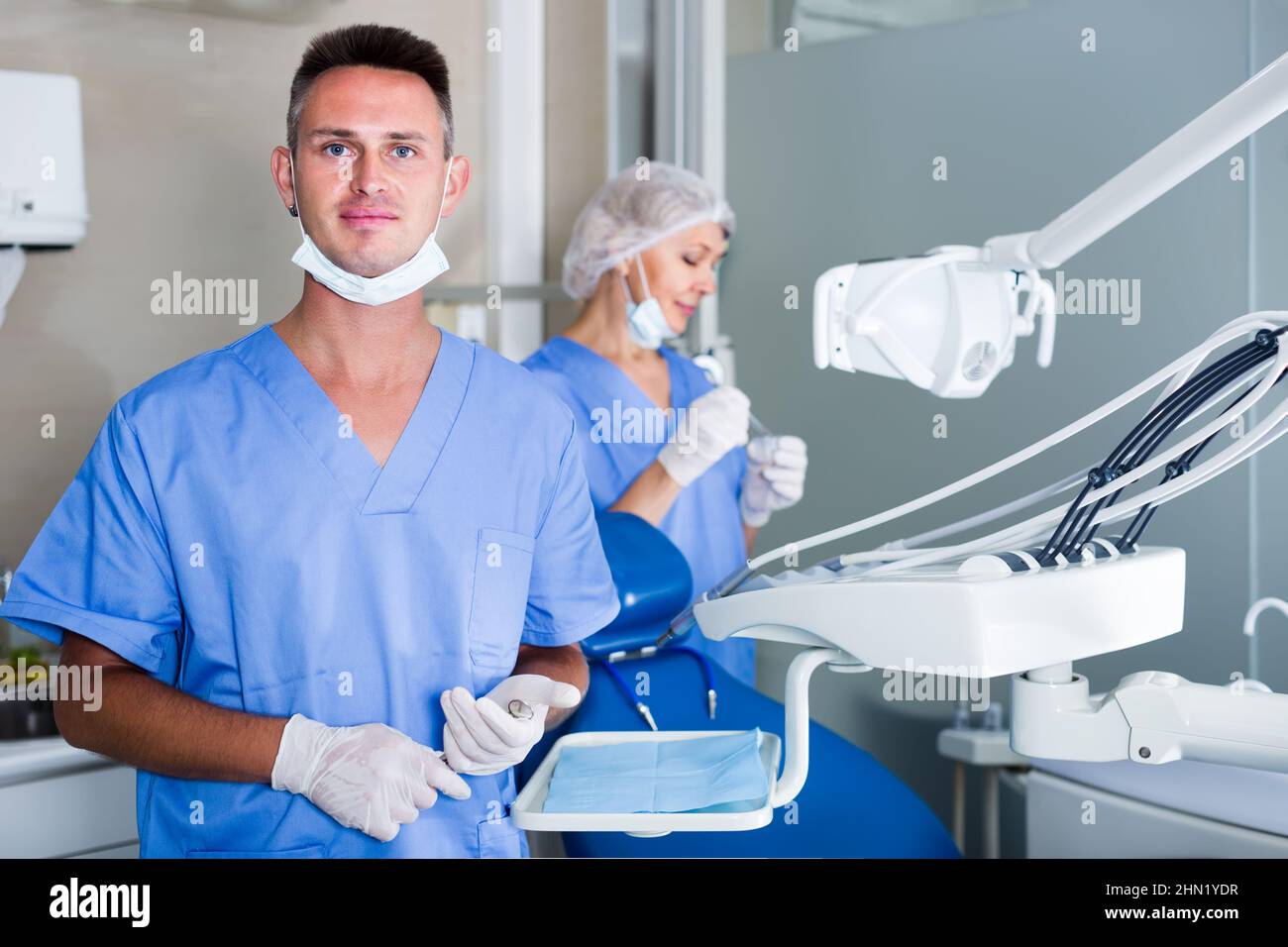 dentist standing in office with dental assistant background Stock Photo