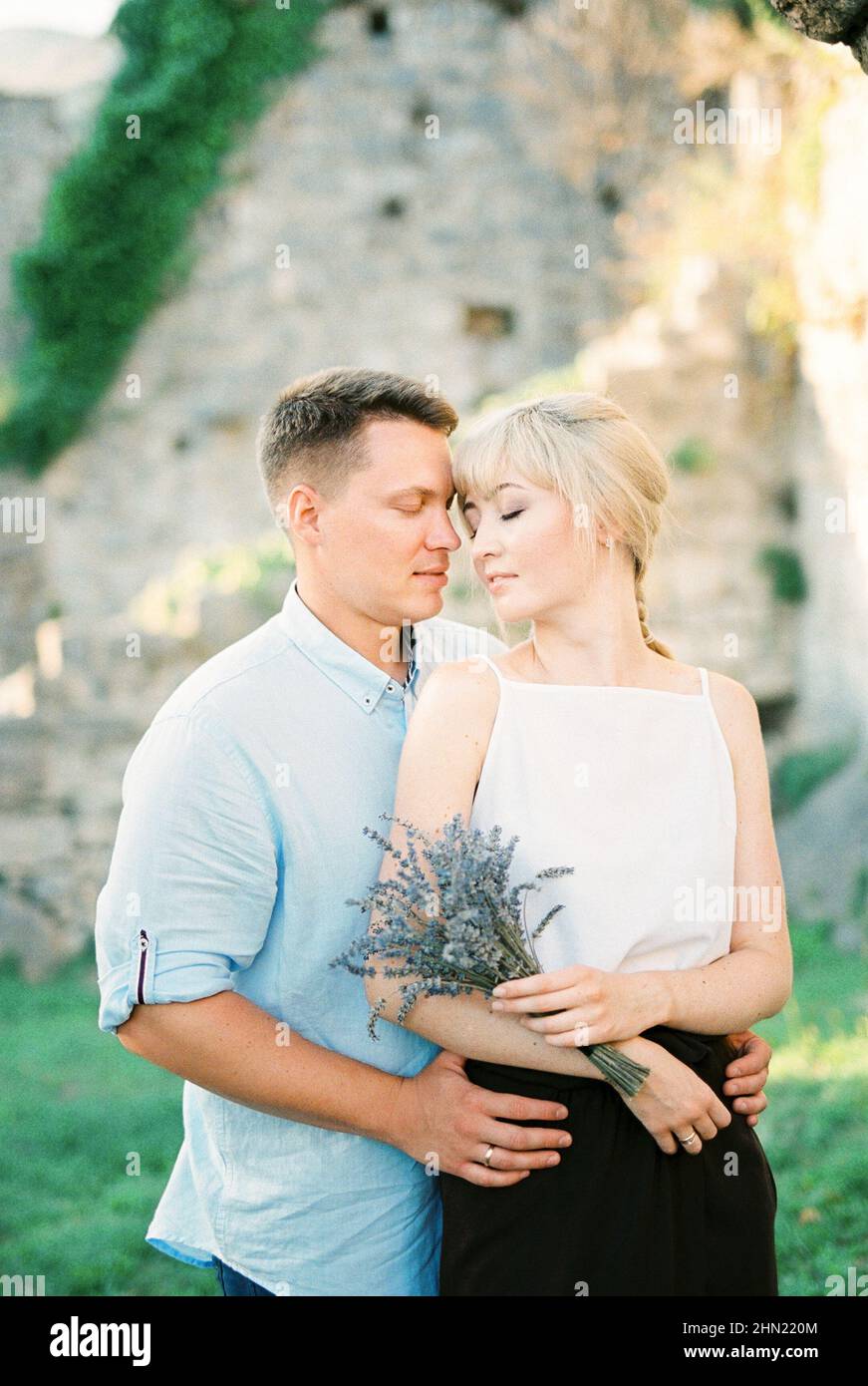 Man hugs woman bouquet hi-res stock photography and images - Alamy