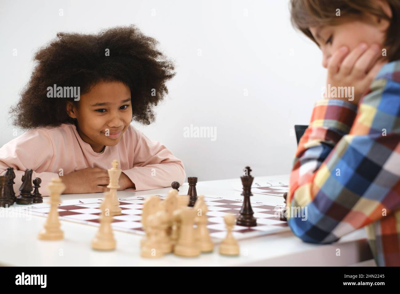 Young white child playing a game of chess on large chess board. Chess board  on table in front of school boy thinking of next move by Len44ik Vectors &  Illustrations with Unlimited