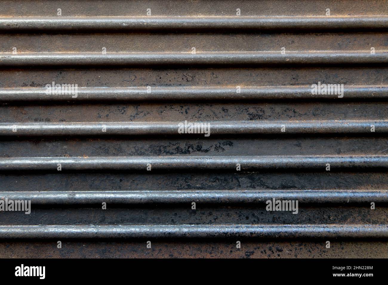 Dark horizontal ribbed rusted grunge background. Old cast iron pan