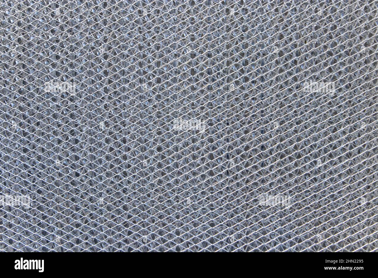Shiny metallic futuristic technological background. Fine diamond-shaped metal mesh Stock Photo