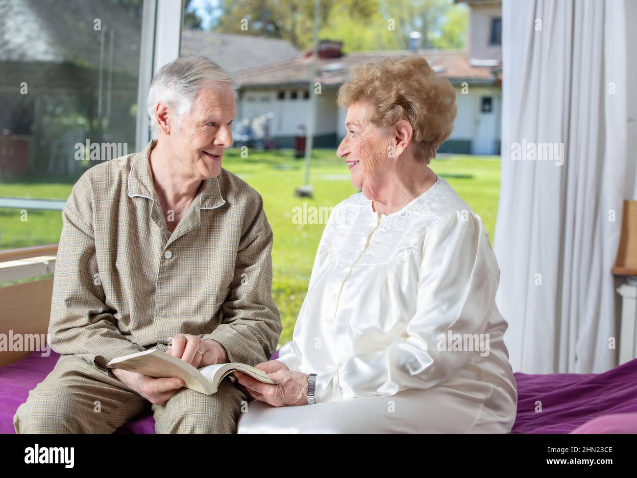Caucasian seniors smiling at rehab clinic. Retired elderly people living their life at its best Stock Photo