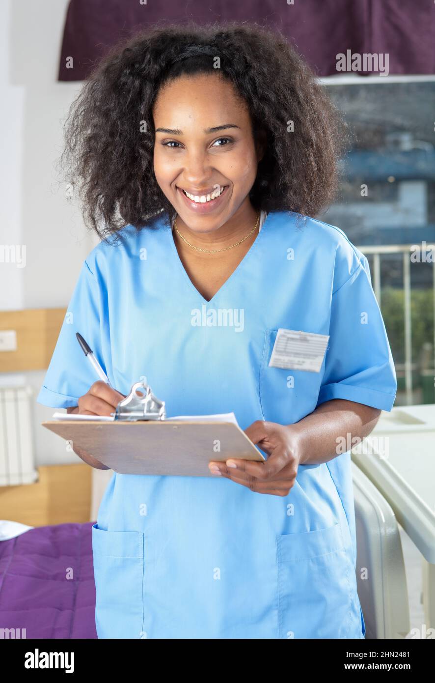 Confident female african doctor at the hospital holding the medical folder Stock Photo