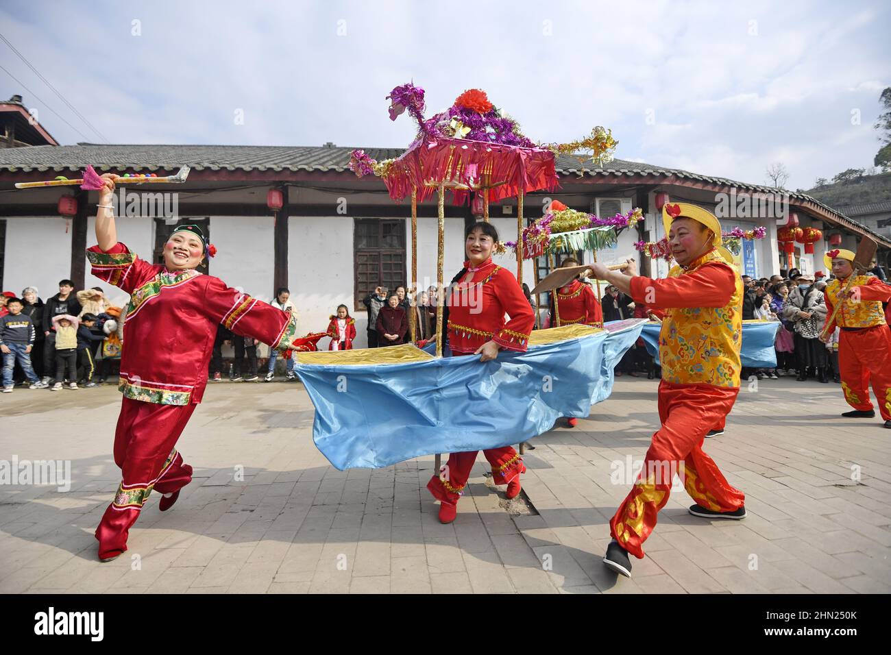 Nanchong, China's Sichuan Province. 13th Feb, 2022. Volunteers perform at Zhouzi ancient town in Peng'an County of Nanchong City, southwest China's Sichuan Province, Feb. 13, 2022. Various events are held across China to celebrate the upcoming Lantern Festival. Credit: Li Xiangyu/Xinhua/Alamy Live News Stock Photo