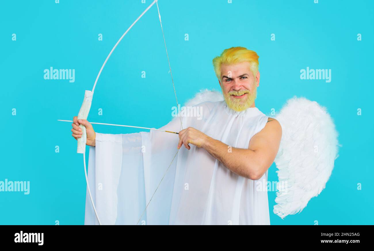 Valentines day celebration. Male angel throws arrow with bow. Cupid in valentine day. Arrows of love. Stock Photo