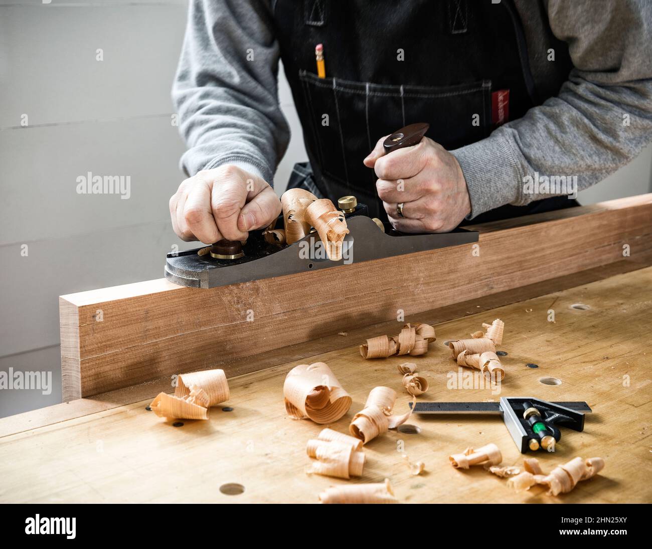 Woodworker hand planing with a low angle Jack Plane. Stock Photo