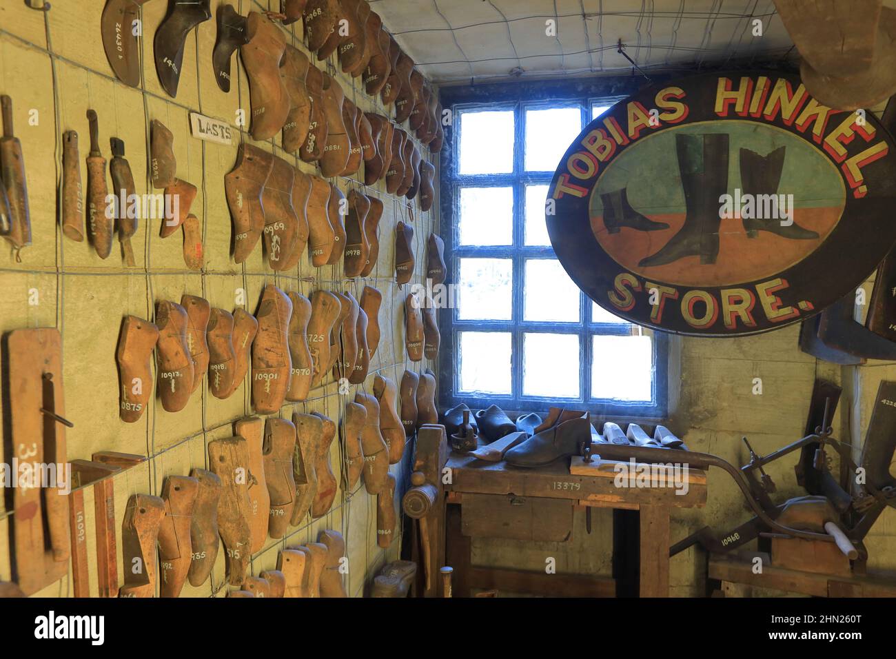 Antique shoe making tools, shoe lasts and business sign display in