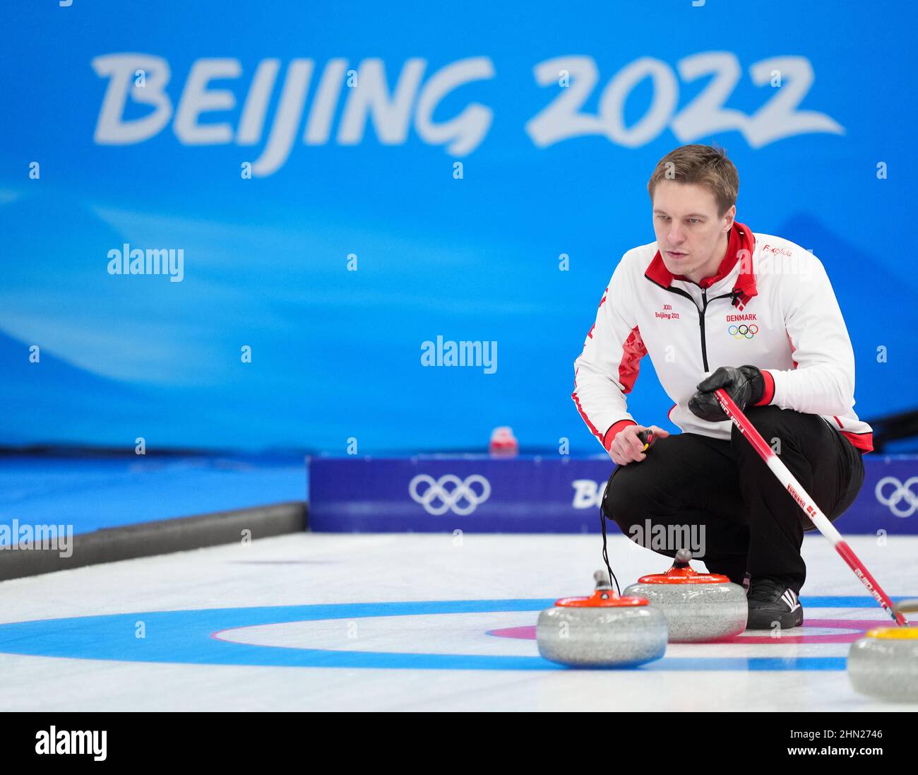 Beijing, China. 13th Feb, 2022. Mikkel Krause of Denmark competes during the curling men's round robin session 7 of the Beijing 2022 Winter Olympics between Britain and Denmark at the National Aquatics Centre in Beijing, capital of China, Feb. 13, 2022. Credit: Zhou Mi/Xinhua/Alamy Live News Stock Photo