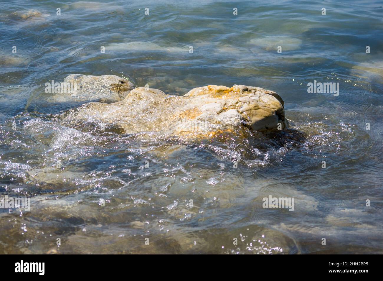 rocky sea shore with pebble beach, waves with foam Stock Photo - Alamy