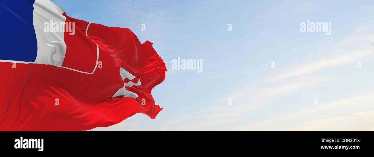official flag of Wallis and Futuna at cloudy sky background on sunset ...