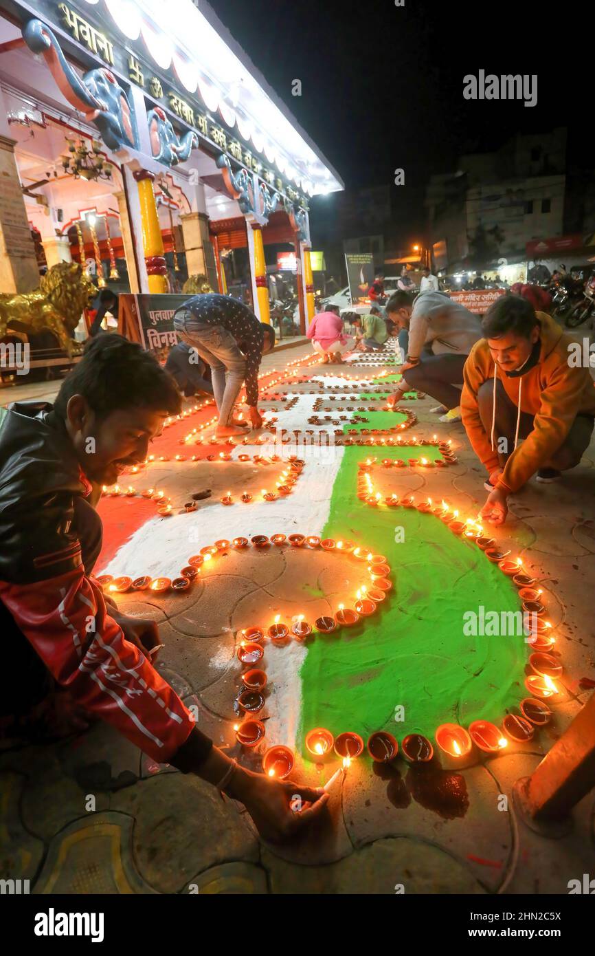 Bhopal, India. 13th Feb, 2022. Members of a social organization light lamps to pay tribute to the slain 40 soldiers of Central Reserve Police Force killed in Pulwama attack on the eve of the third anniversary of the incident. A Pakistan-backed Jaish-e-Mohammed suicide bomber rammed an explosive-laden vehicle into a CRPF convoy at Jammu-Srinagar highway in Pulwama district on Feb14, 2019. (Photo by Sanjeev Gupta/SOPA Images/Sipa USA) Credit: Sipa USA/Alamy Live News Stock Photo