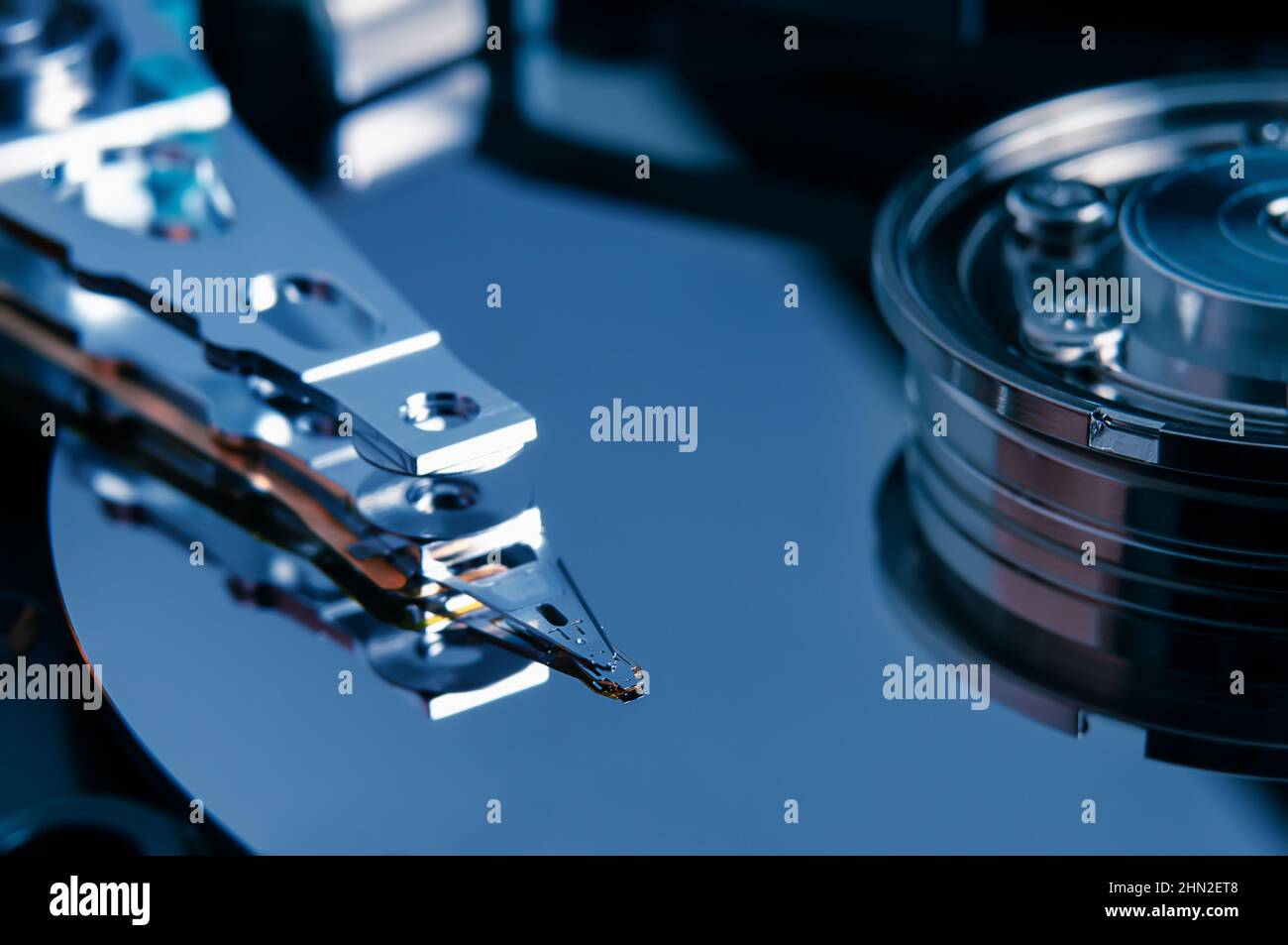 Open hard disk drive with magnetic head closeup. Stock Photo